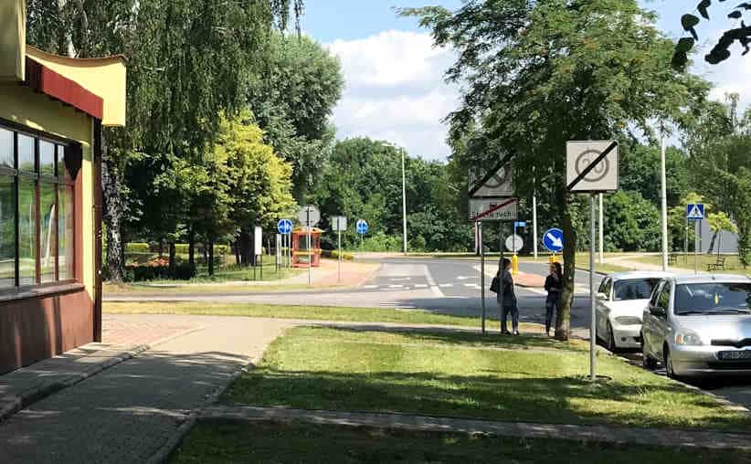 Obozowa Street with the 'Museum II' bus stop and part of the grocery store building near Auschwitz I