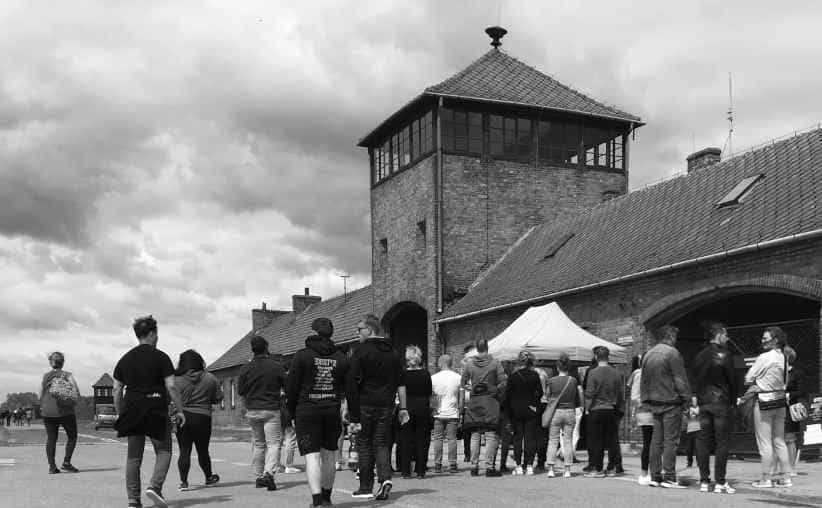 Visitors in front of the main gate at Auschwitz II Birkenau