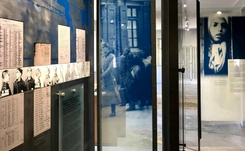 Prisoner lists and photos on glass walls in Block 14: Roma exhibition, Auschwitz I Main Camp.