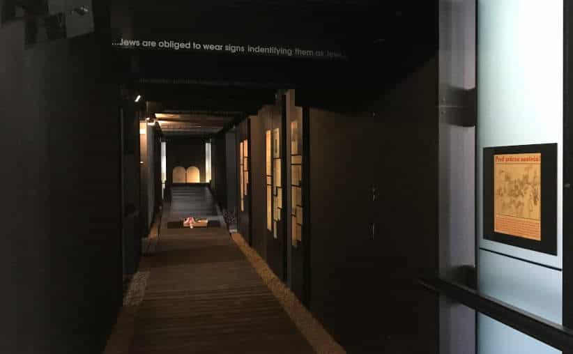 Dark corridor with info on walls in Block 16: Slovakian national exhibition, Auschwitz I Main Camp.