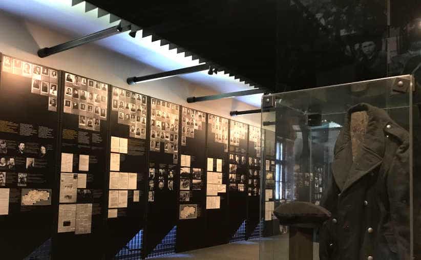 Glass display with a soldier uniform and info boards in Block 16: Slovakian national exhibition, Auschwitz I Main Camp.