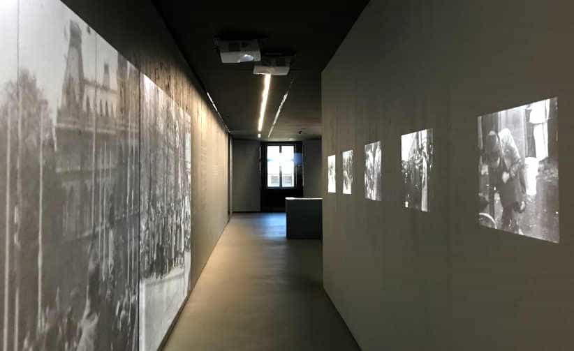 Corridor with WWII photos projected on the walls in Block 17: Austrian national exhibition, Auschwitz I Main Camp.