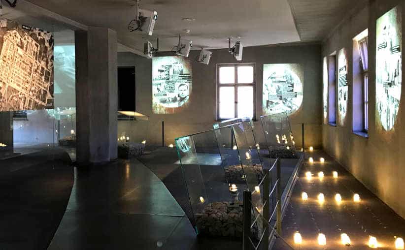 Light bulbs on the floor and projected info graphics in Block 18: Hungarian national exhibition, Auschwitz I Main Camp.