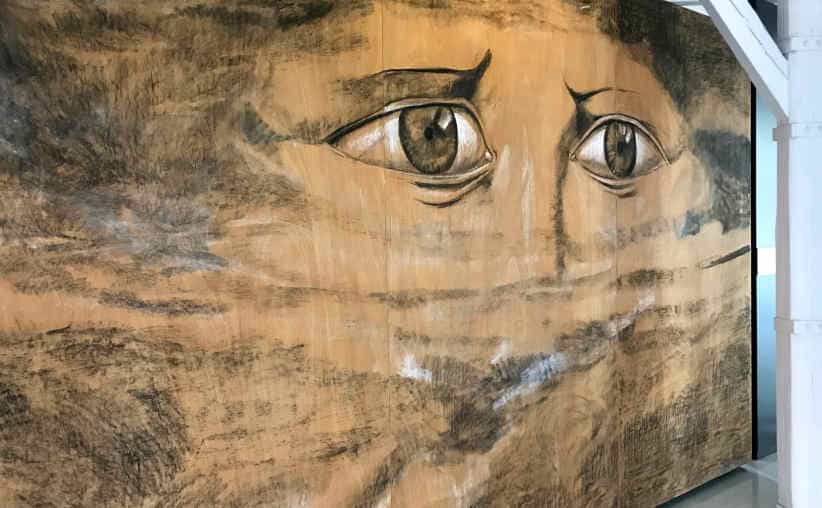 A huge painting of human eyes in Block 20: Belgian national exhibition, Auschwitz I Main Camp.
