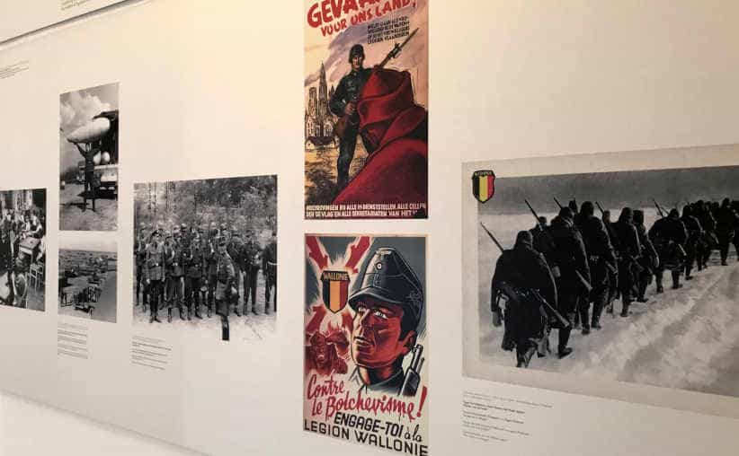 Posters and photos on a wall in Block 20: Belgian national exhibition, Auschwitz I Main Camp.