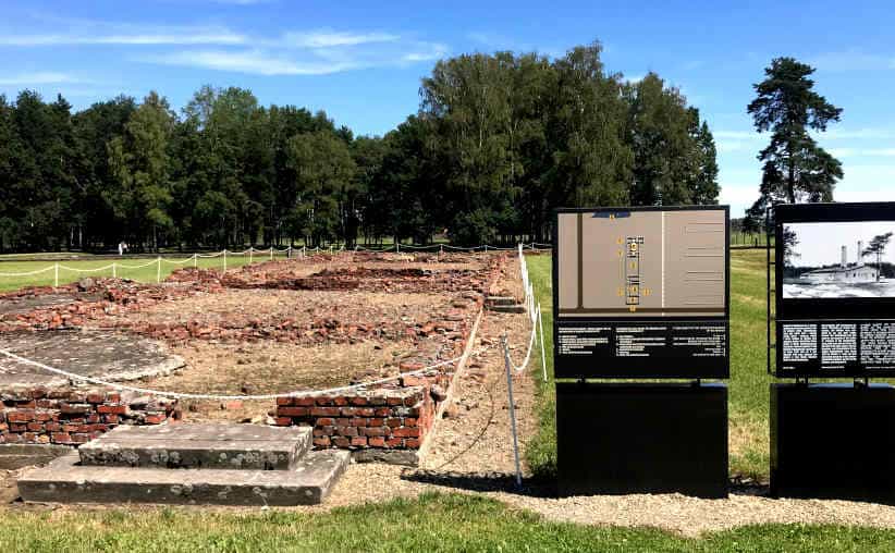 The ruins, boards with text, photo and the drawing plan of Crematorium and Gas Chamber IV at Auschwitz-II-Birkenau.