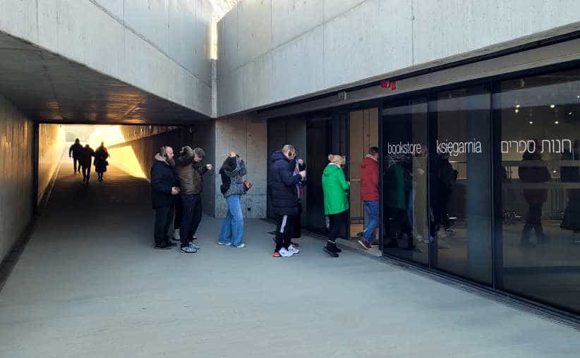 Visitors entering the main reception after visiting Auschwitz I Main Camp to return the headsets.