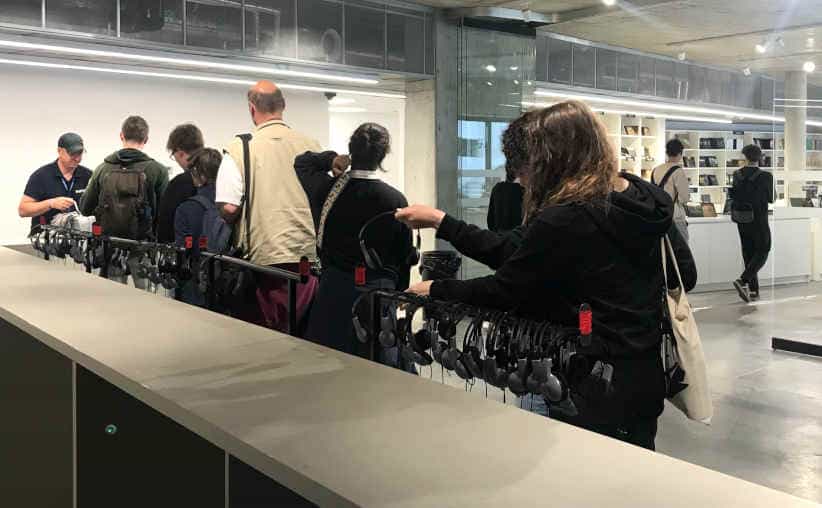 Visitors returning headsets at the Auschwitz I Main Camp tour end