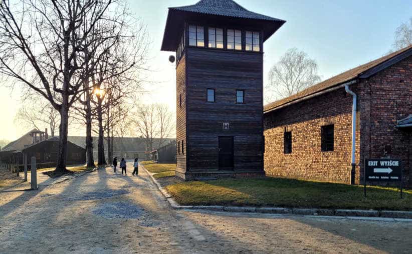 Guard tower near Auschwitz I Crematorium and Gas Chamber with exit info board on the right.