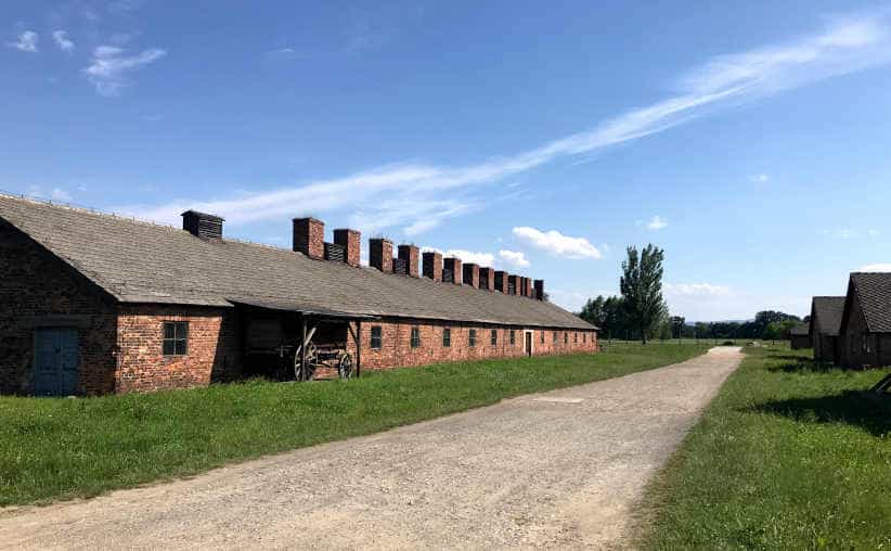 Camp kitchen with a wooden cart and brick buildings at Auschwitz-II-Birkenau, sector BIb.