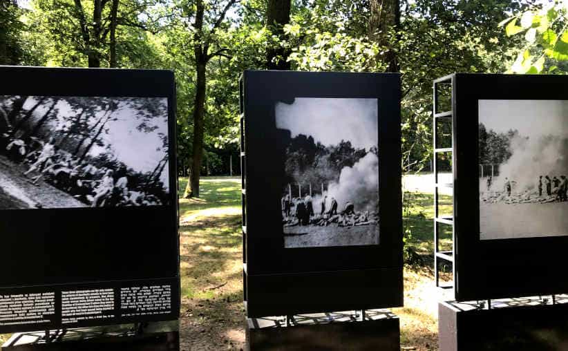 Boards with photos showing corpses being burned outside near the Crematorium and Gas Chamber V ruins at Auschwitz-II-Birkenau.