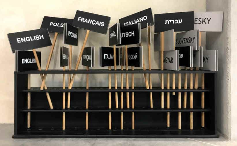 Boards with languages of Auschwitz guided tours at the Museum reception hallway