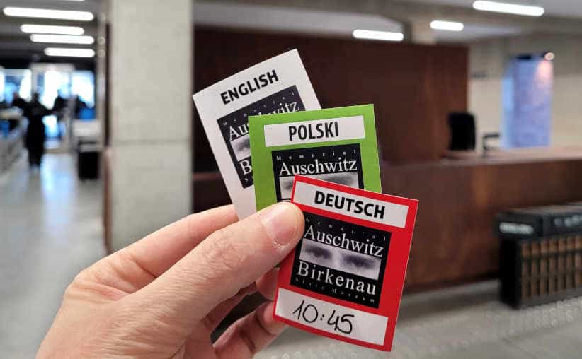 Stickers for joint tours with information desk in the background, Auschwitz I reception building.