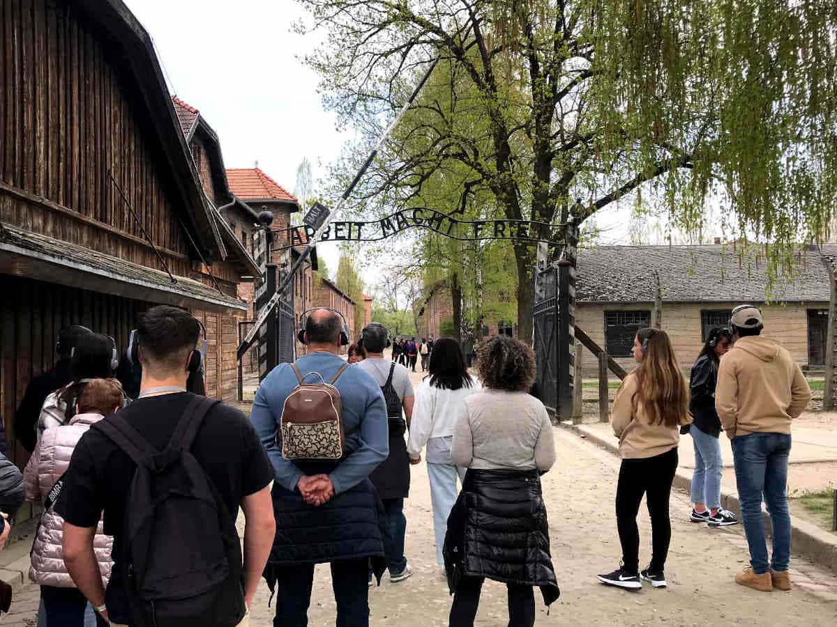 Visitors in front of the main Auschwitz gate